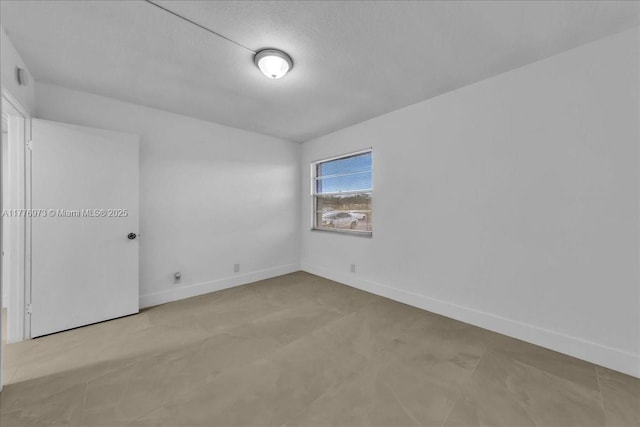 650 SW 124th Ter Unit 105P, Pembroke Pines, FL 33027 - empty room with baseboards and a textured ceiling