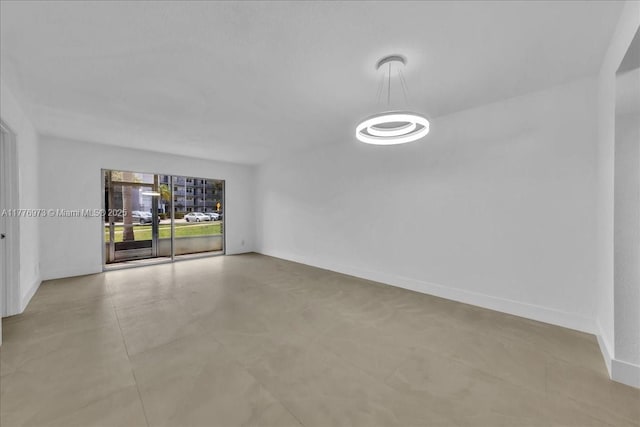 650 SW 124th Ter Unit 105P, Pembroke Pines, FL 33027 - spare room featuring baseboards