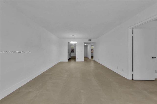 650 SW 124th Ter Unit 105P, Pembroke Pines, FL 33027 - unfurnished living room with baseboards and concrete flooring