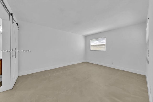 650 SW 124th Ter Unit 105P, Pembroke Pines, FL 33027 - unfurnished bedroom featuring a barn door and baseboards