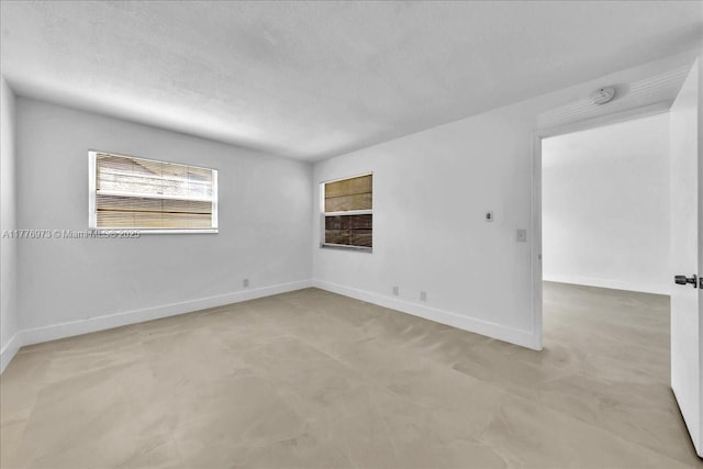 650 SW 124th Ter Unit 105P, Pembroke Pines, FL 33027 - empty room featuring a smoke detector, baseboards, and a textured ceiling