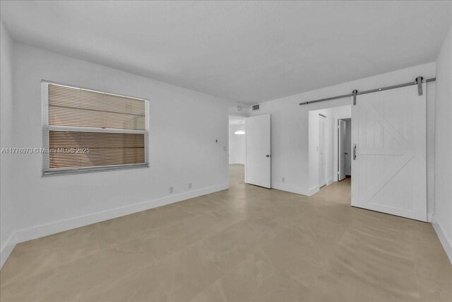 650 SW 124th Ter Unit 105P, Pembroke Pines, FL 33027 - unfurnished room featuring baseboards and a barn door