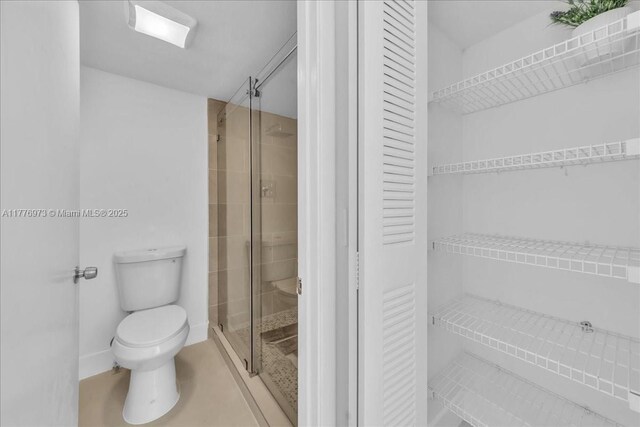 650 SW 124th Ter Unit 105P, Pembroke Pines, FL 33027 - bathroom featuring toilet, a stall shower, and a closet