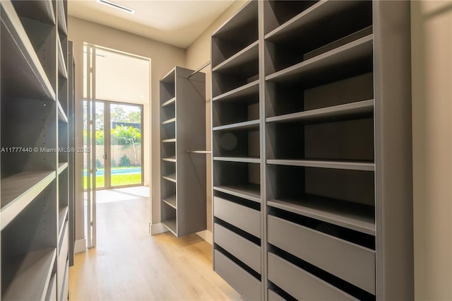 spacious closet with visible vents and light wood-style floors