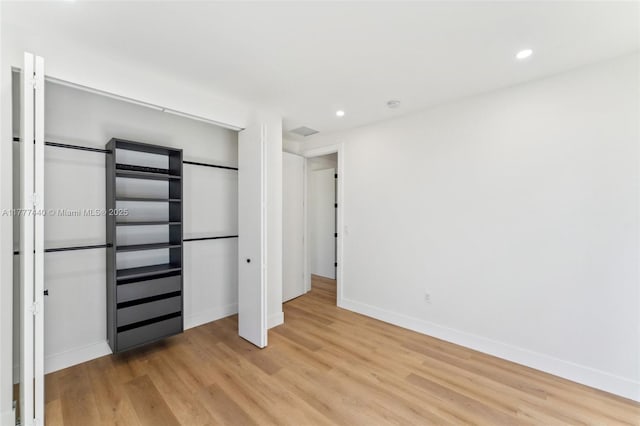 unfurnished bedroom featuring recessed lighting, baseboards, and light wood-type flooring