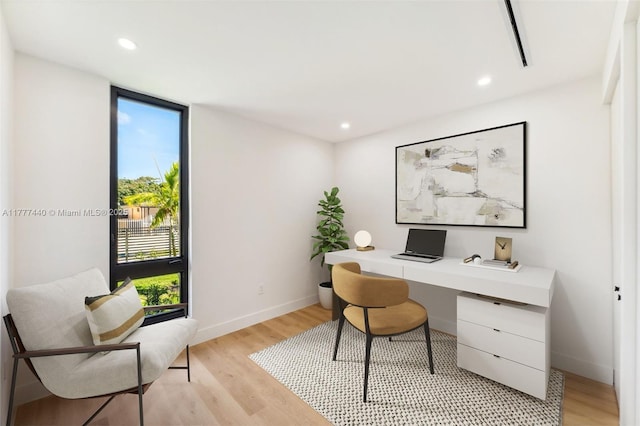 office space with plenty of natural light, baseboards, light wood-style floors, and recessed lighting