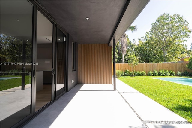 view of patio / terrace featuring fence and a fenced in pool