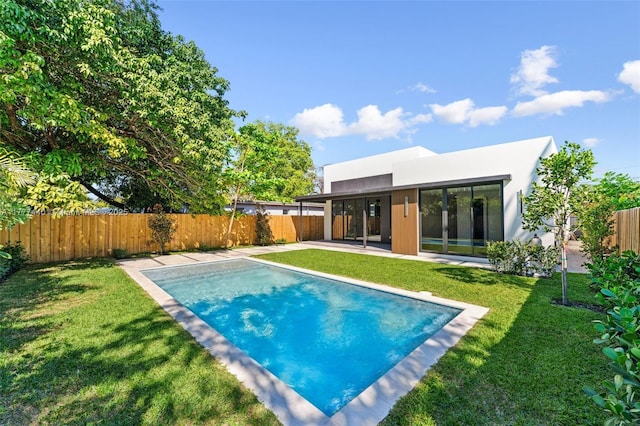 view of pool with a fenced backyard, a patio area, and a yard