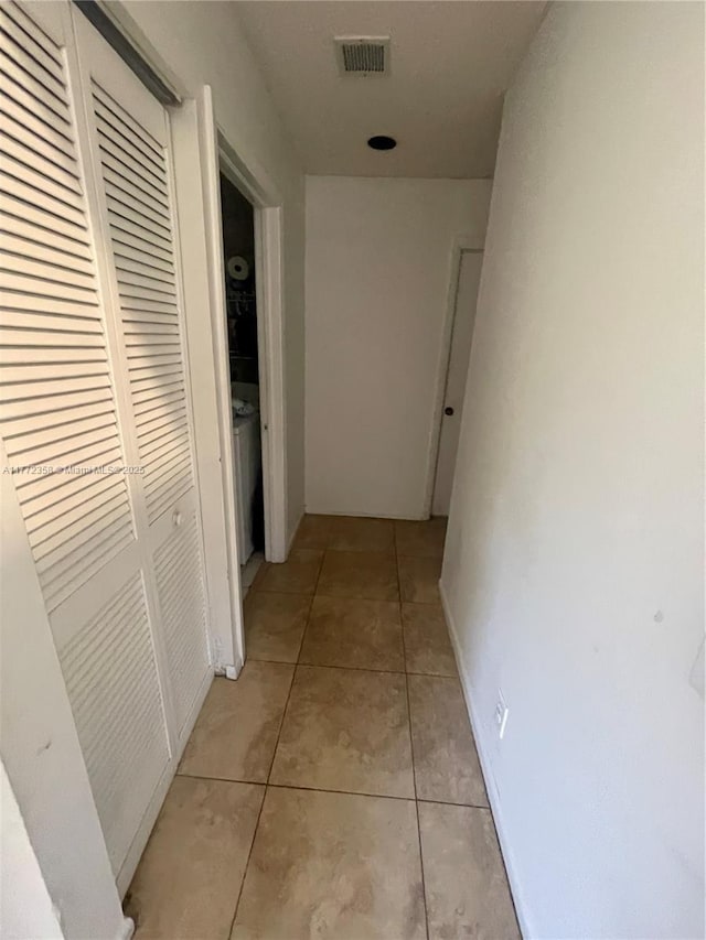 corridor with visible vents and light tile patterned floors