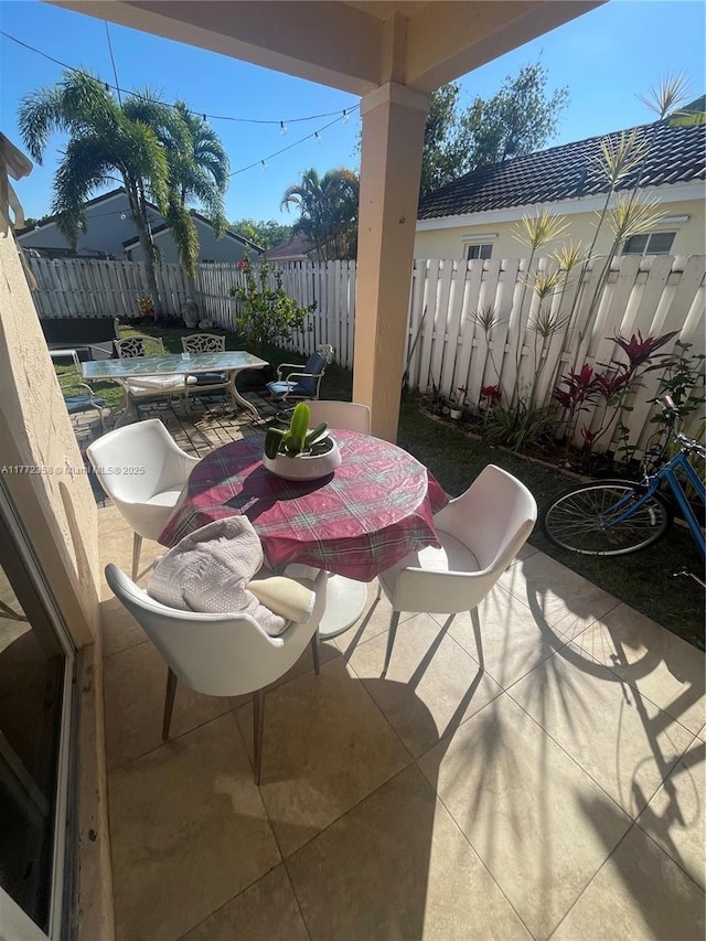 view of patio / terrace featuring fence and outdoor dining space