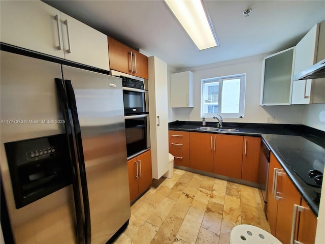 170 SE 14th St Unit 2705, Miami, FL 33131 - kitchen featuring stainless steel appliances, a sink, stone tile floors, dark countertops, and brown cabinetry