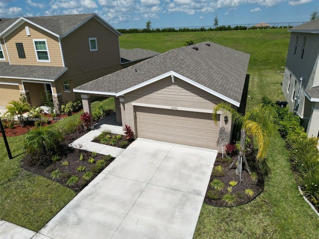 view of front of home with an attached garage, concrete driveway, a front lawn, roof with shingles, and stucco siding