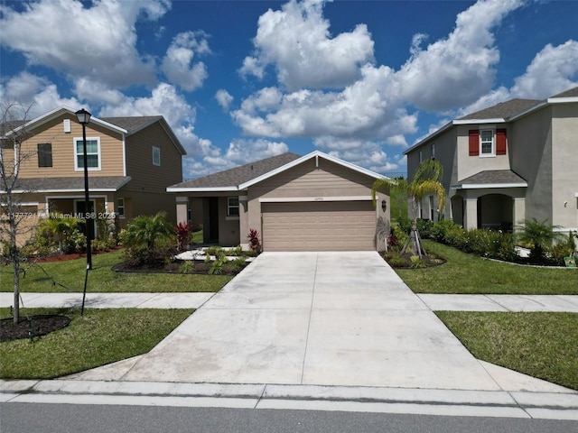 traditional-style house featuring stucco siding, a garage, a front lawn, and concrete driveway