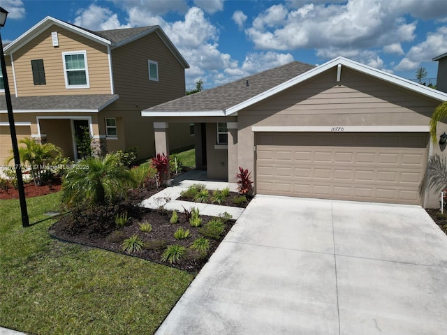 view of front of home with driveway, stucco siding, an attached garage, and roof with shingles
