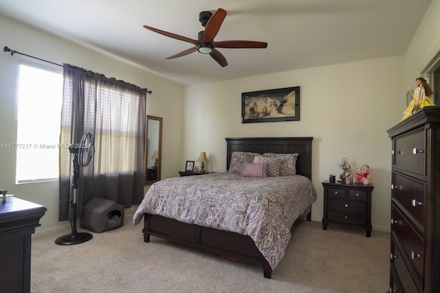 bedroom featuring light colored carpet and a ceiling fan