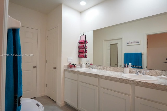 full bathroom featuring double vanity and a sink