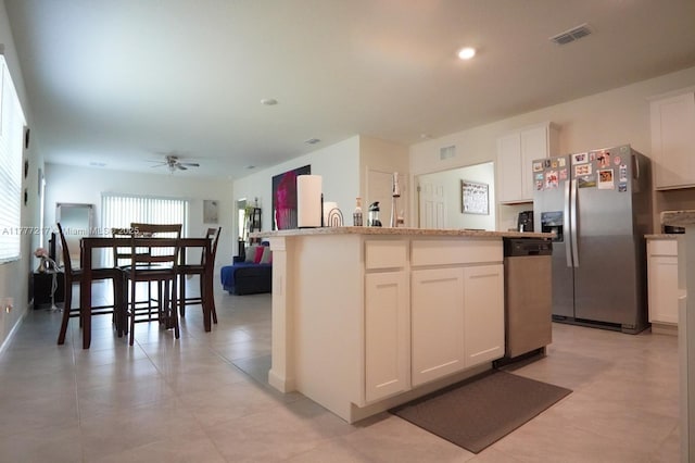 kitchen with white cabinetry, appliances with stainless steel finishes, ceiling fan, and visible vents