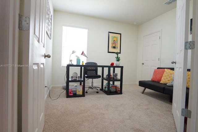 carpeted office space featuring baseboards and visible vents