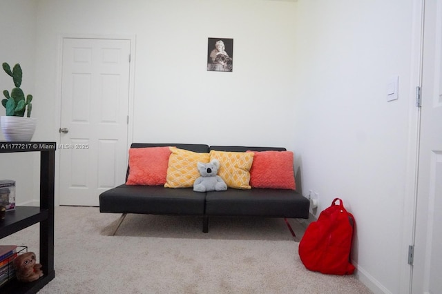 living area with carpet flooring and baseboards