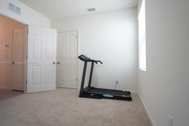 workout area with baseboards, visible vents, and carpet
