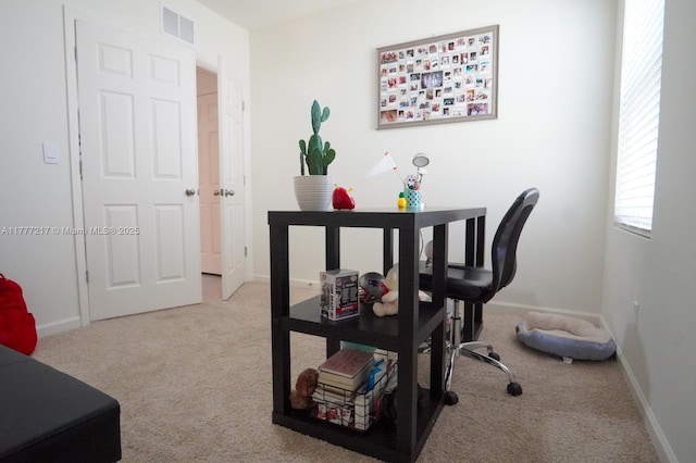carpeted office with baseboards and visible vents