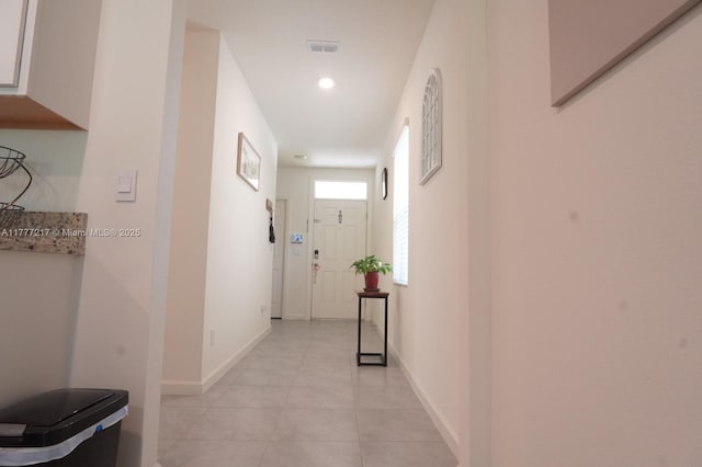 hall with baseboards, visible vents, recessed lighting, and light tile patterned floors