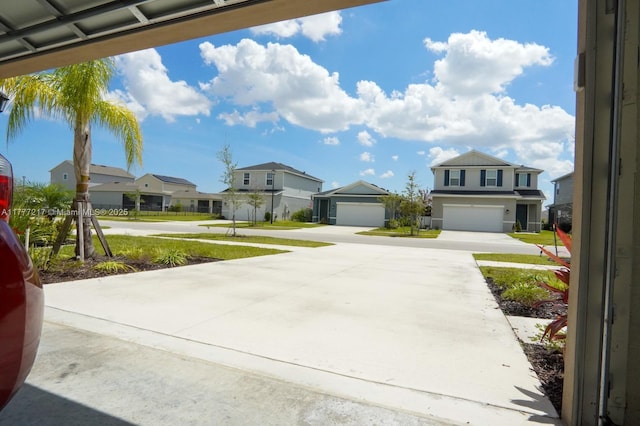 exterior space featuring concrete driveway and a residential view