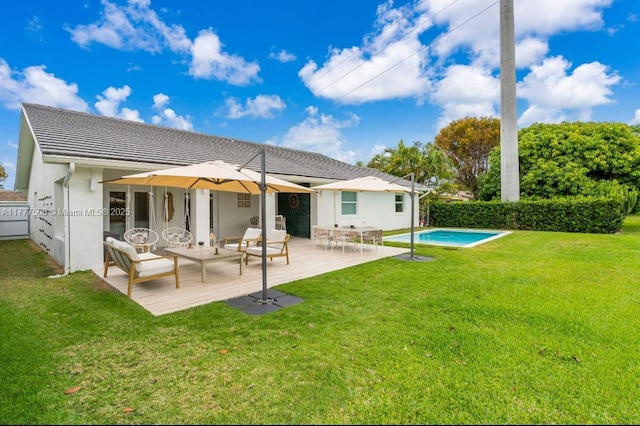 back of house with a patio, stucco siding, an outdoor living space, a yard, and fence
