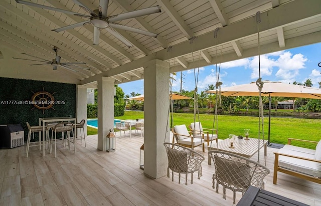 wooden deck featuring an outdoor hangout area, an outdoor pool, a lawn, and ceiling fan