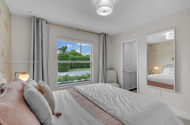 bedroom with connected bathroom and a textured ceiling