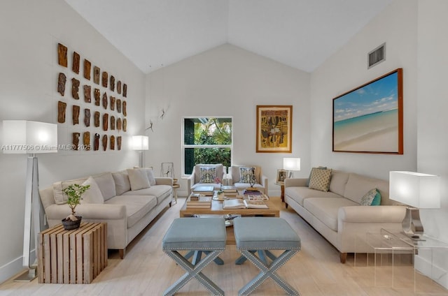 living area with visible vents and lofted ceiling