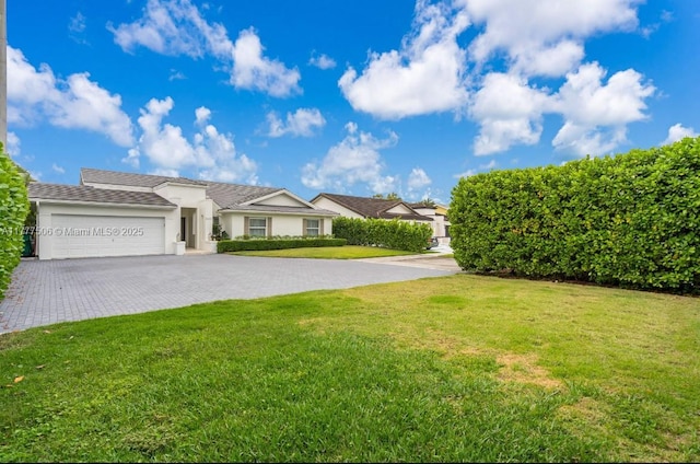 ranch-style home with a front lawn, stucco siding, decorative driveway, and an attached garage
