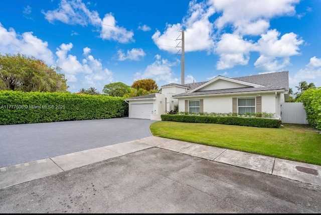 single story home with stucco siding, a front lawn, aphalt driveway, a garage, and fence
