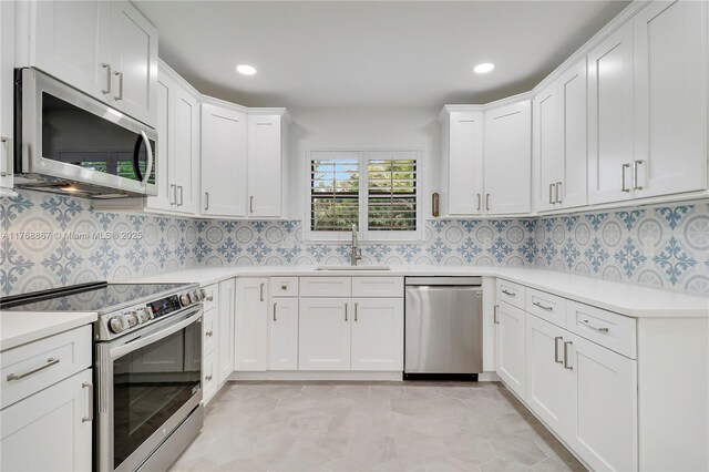 3774 SW Pheasant Run, Palm City, FL 34990 - kitchen with appliances with stainless steel finishes, a sink, light countertops, white cabinets, and recessed lighting