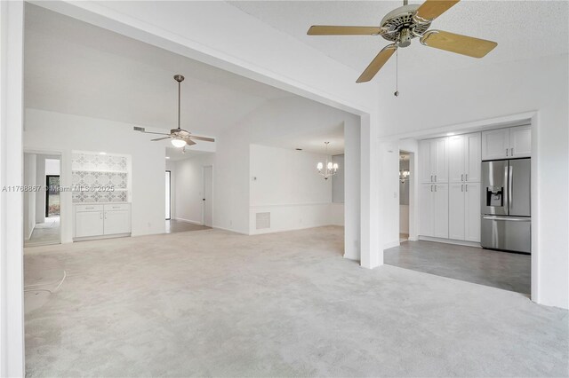 3774 SW Pheasant Run, Palm City, FL 34990 - unfurnished living room with ceiling fan, lofted ceiling, a chandelier, and light carpet