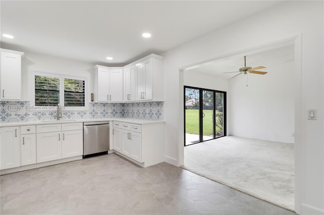 3774 SW Pheasant Run, Palm City, FL 34990 - kitchen featuring dishwasher, light countertops, light carpet, a ceiling fan, and white cabinets