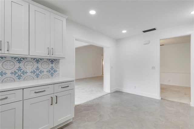 3774 SW Pheasant Run, Palm City, FL 34990 - kitchen with light countertops, recessed lighting, light colored carpet, white cabinetry, and baseboards