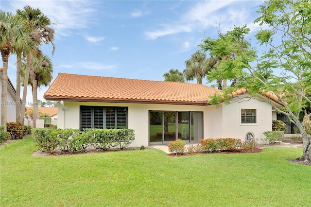 3774 SW Pheasant Run, Palm City, FL 34990 - rear view of house featuring a tiled roof, stucco siding, and a yard