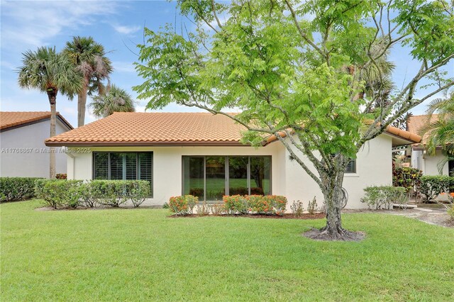 3774 SW Pheasant Run, Palm City, FL 34990 - rear view of property featuring stucco siding, a yard, and a tiled roof