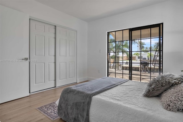 5860 SW 13th St, Plantation, FL 33317 - bedroom with access to outside, a closet, and wood finished floors