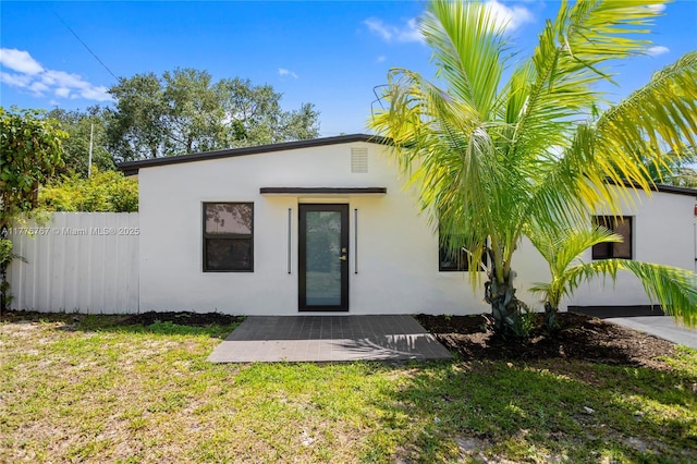 1640 NE 183rd St, North Miami Beach, FL 33179 - rear view of house with stucco siding and a patio