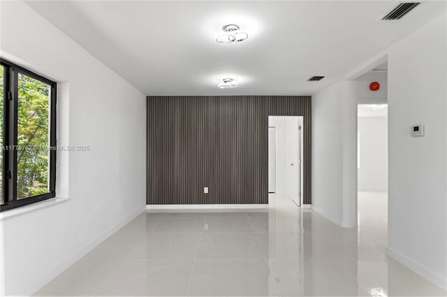 1640 NE 183rd St, North Miami Beach, FL 33179 - unfurnished room featuring an accent wall and baseboards