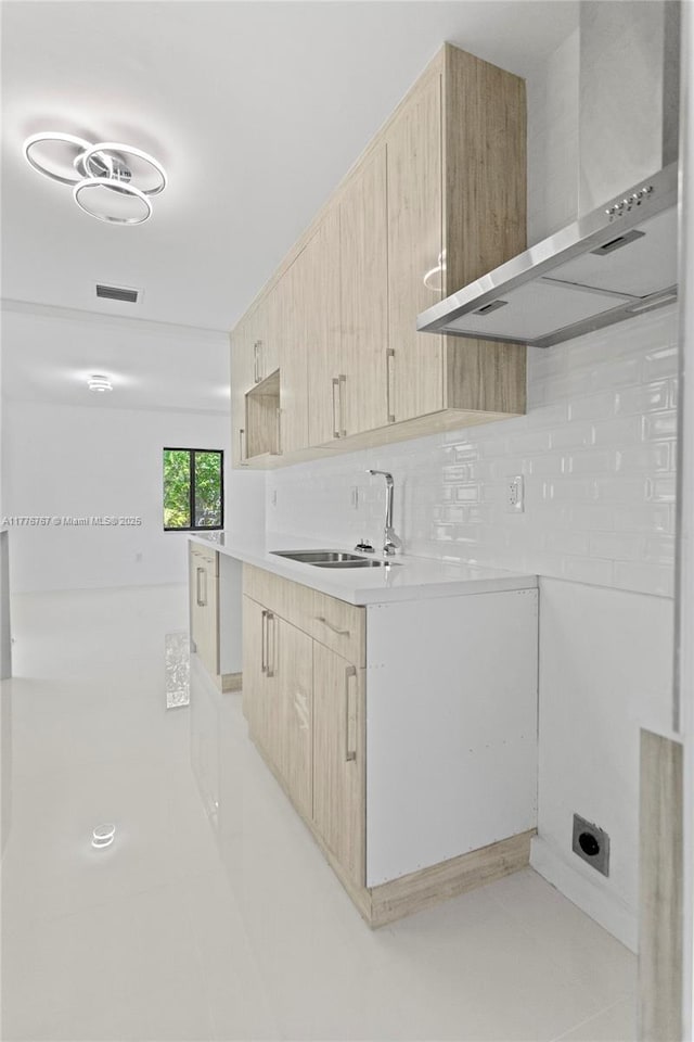 1640 NE 183rd St, North Miami Beach, FL 33179 - kitchen featuring light brown cabinets, wall chimney exhaust hood, a sink, decorative backsplash, and light countertops
