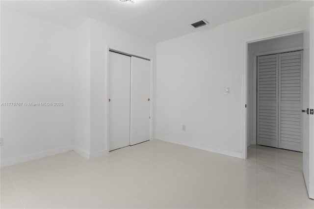 1640 NE 183rd St, North Miami Beach, FL 33179 - unfurnished bedroom featuring light tile patterned flooring, a closet, and baseboards