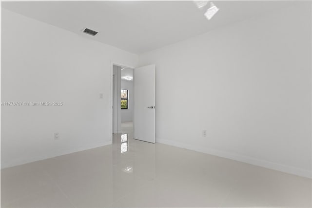 1640 NE 183rd St, North Miami Beach, FL 33179 - spare room featuring tile patterned floors and baseboards