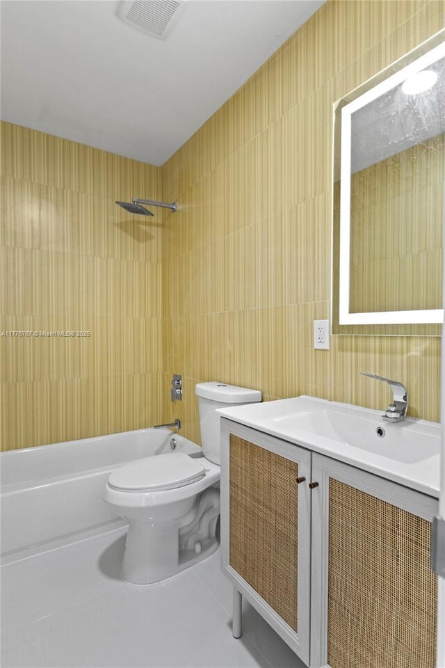 1640 NE 183rd St, North Miami Beach, FL 33179 - bathroom featuring tile walls, toilet, washtub / shower combination, vanity, and tile patterned floors