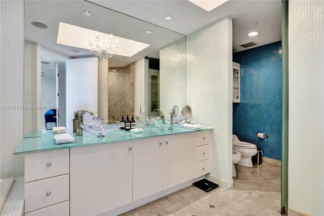 100 S Pointe Dr Unit 3102, Miami Beach, FL 33139 - bathroom with tile walls, a bidet, a shower stall, toilet, and double vanity