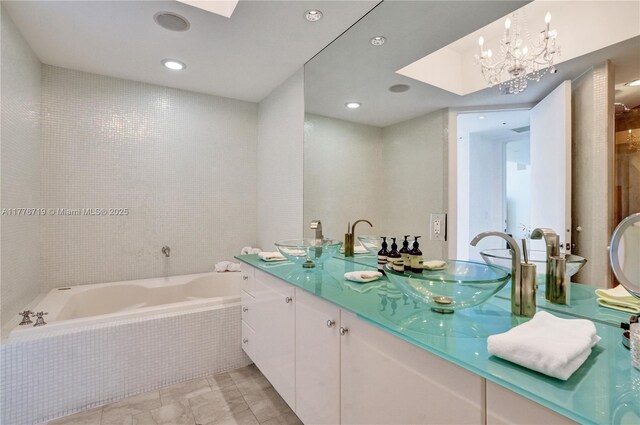 100 S Pointe Dr Unit 3102, Miami Beach, FL 33139 - bathroom featuring a garden tub, double vanity, recessed lighting, and a skylight