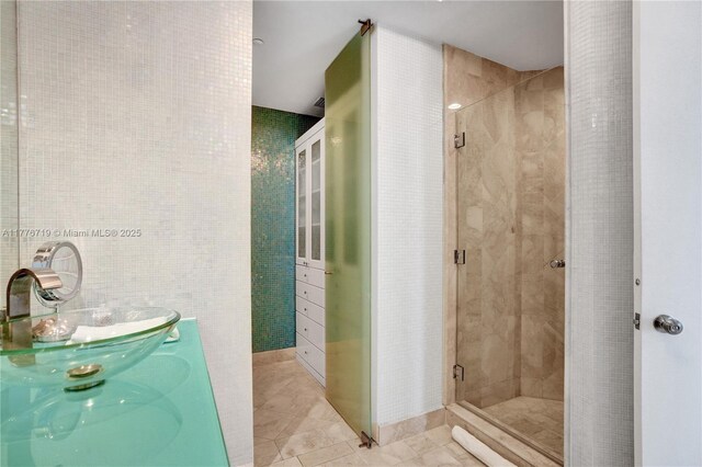 100 S Pointe Dr Unit 3102, Miami Beach, FL 33139 - full bathroom featuring a sink, a shower stall, and tile walls