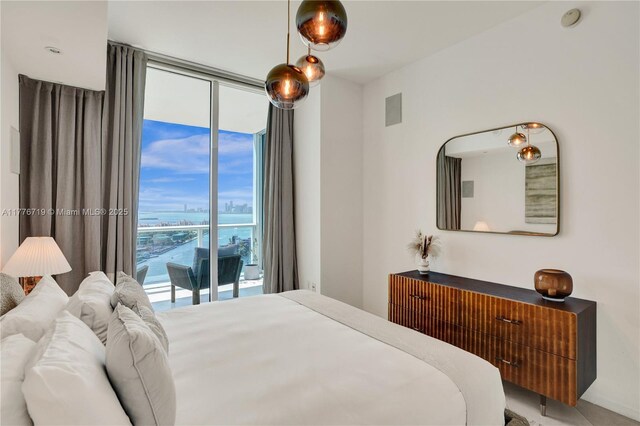 100 S Pointe Dr Unit 3102, Miami Beach, FL 33139 - bedroom with access to outside, expansive windows, and a water view